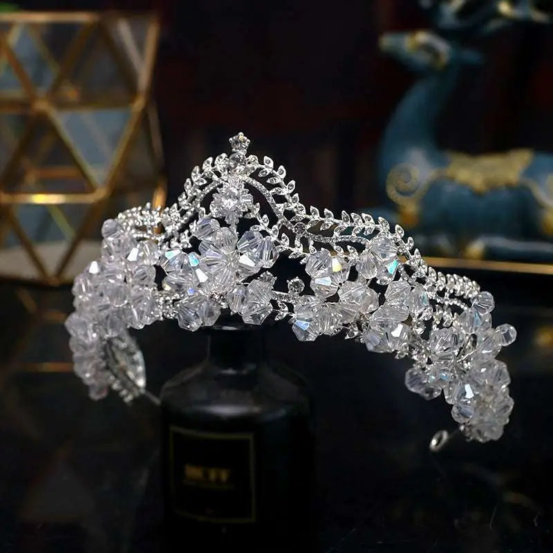 A sparkling silver bridal crown baroque adorned with clear faceted crystal flowers and crystal leaf bridal details