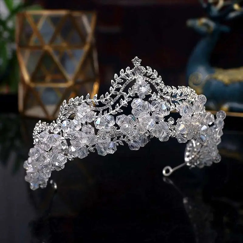 A sparkling silver crown baroque adorned with clear faceted crystal leaf bridal flowers and leafy embellishments