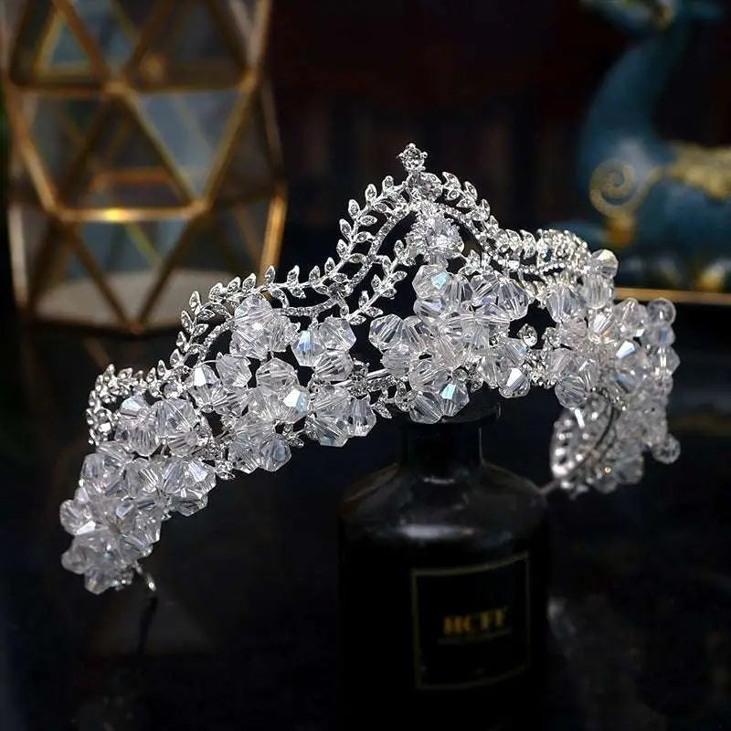 A sparkling silver bridal crown baroque featuring clear crystal flowers and delicate crystal leaf bridal vines