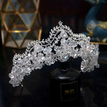 A sparkling silver bridal crown baroque featuring clear crystal flowers and delicate crystal leaf bridal vines