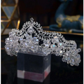 A sparkling silver bridal crown baroque with crystal leaf designs and large faceted beads for bridal use