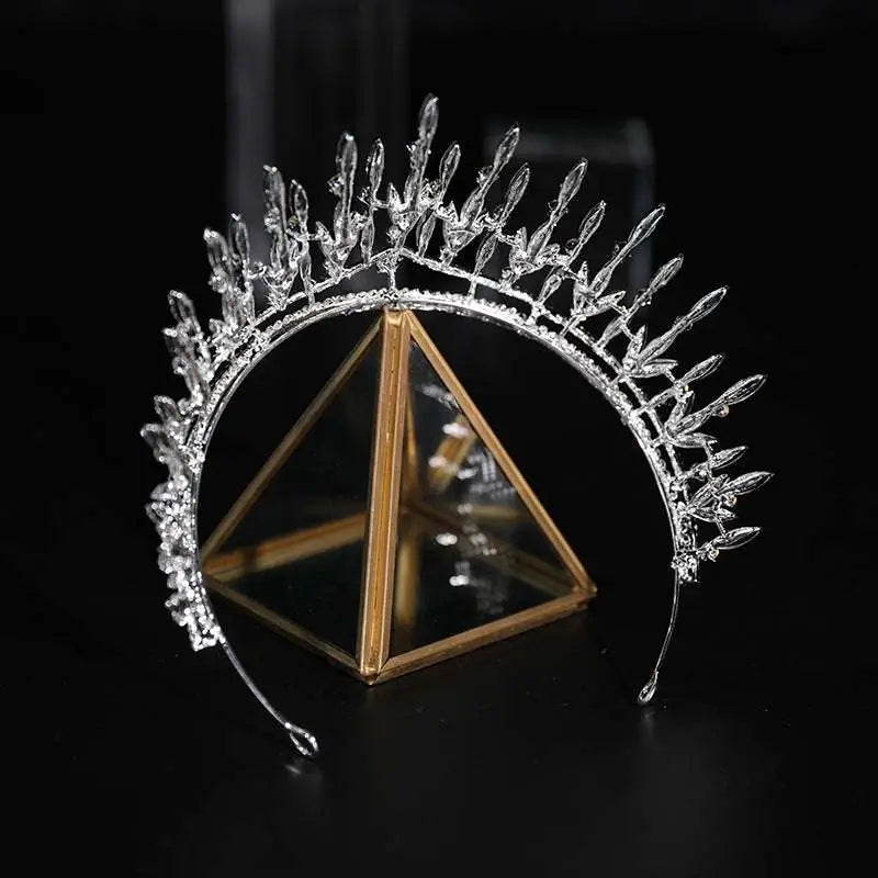 Silver crystal makeup headdress super beautiful crown with elongated marquise crystals displayed on glass stand for shooting wedding dress