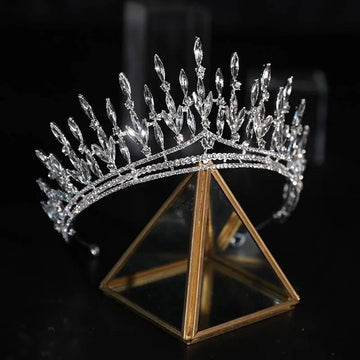 Silver crystal makeup headdress super beautiful crown with elongated marquise crystals displayed on glass stand for shooting wedding dress