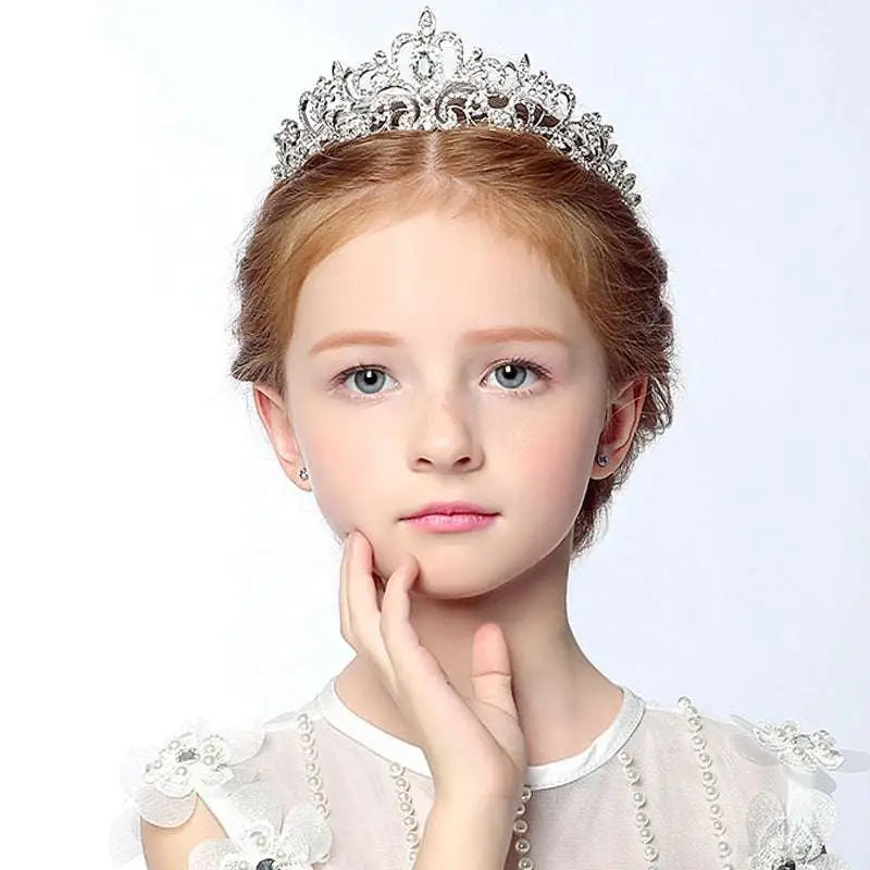 A silver crystal stage flower girl head tiara with intricate filigree and sparkling embedded crystals