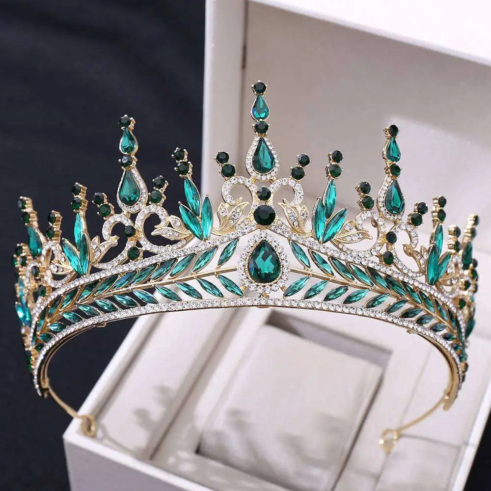 A silver crystal wedding hair hoop crown with emerald green crystals, black gemstones, and clear rhinestones in gold tone