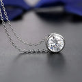 A silver cubic zirconia necklace with a round cut stone in a minimalist bezel from a zirconia bride fashion accessories jewelry set