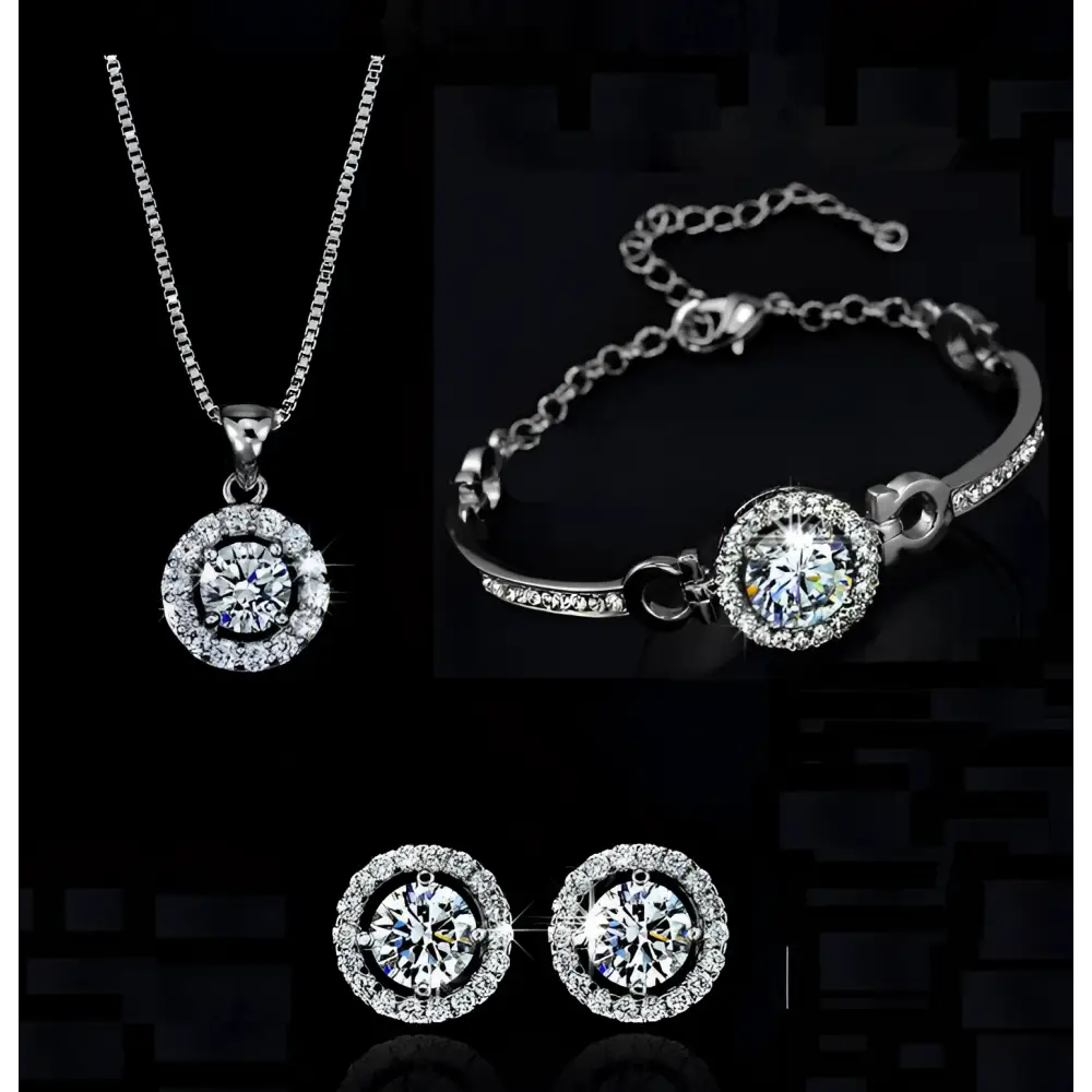 Silver diamond jewelry set featuring a silver-toned necklace bracelet and earrings with central diamonds and pave stones
