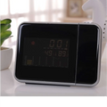Silver digital weather station home electronic clock with black screen and silver frame displaying time and temperature