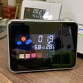 Silver digital weather station home electronic clock with silver frame displaying time temperature humidity and colorful forecast