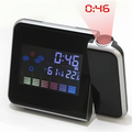 Silver digital weather station home electronic clock with silver frame and black display showing time temperature and humidity