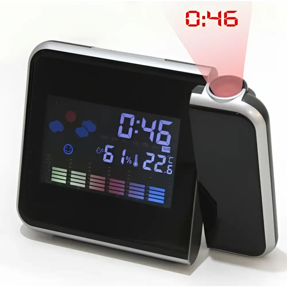 Silver digital weather station home electronic clock with silver frame and black display showing time temperature and humidity