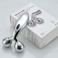 Silver facial roller massage device with two faceted gemstone-like spheres and an ergonomic silver handle