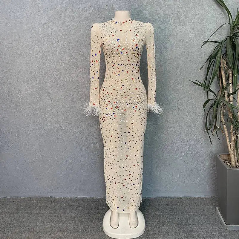 A cream-colored long-sleeved stretch slim dress with rhinestone mesh stretch and silver feathered rhinestone cuffs