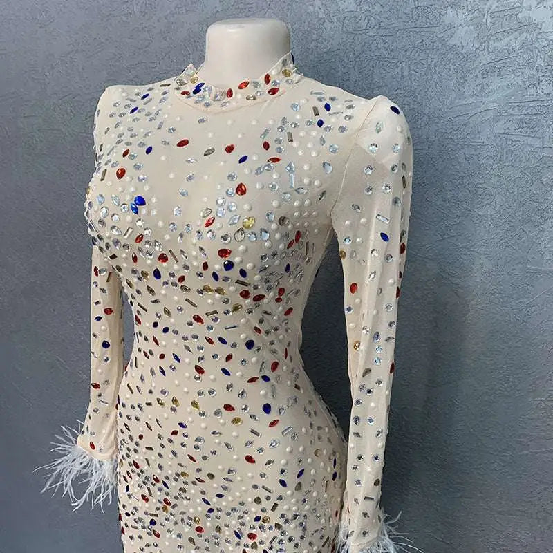A shimmering off-white silver feathered rhinestone mesh stretch slim dress with multicolored rhinestones and feathered cuffs