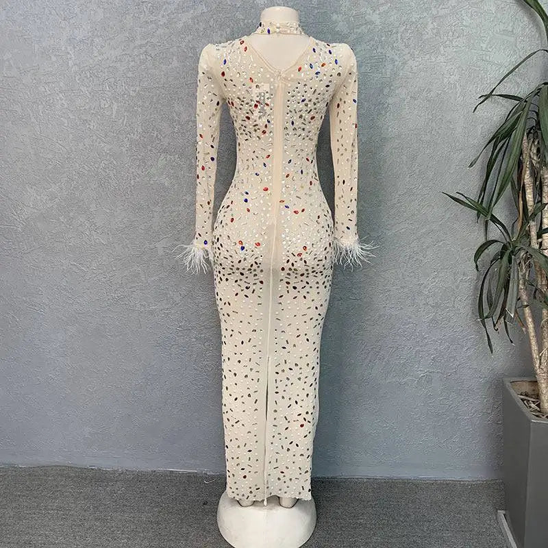 A cream-colored stretch slim dress with colorful rhinestone mesh stretch and silver feathered rhinestone cuffs