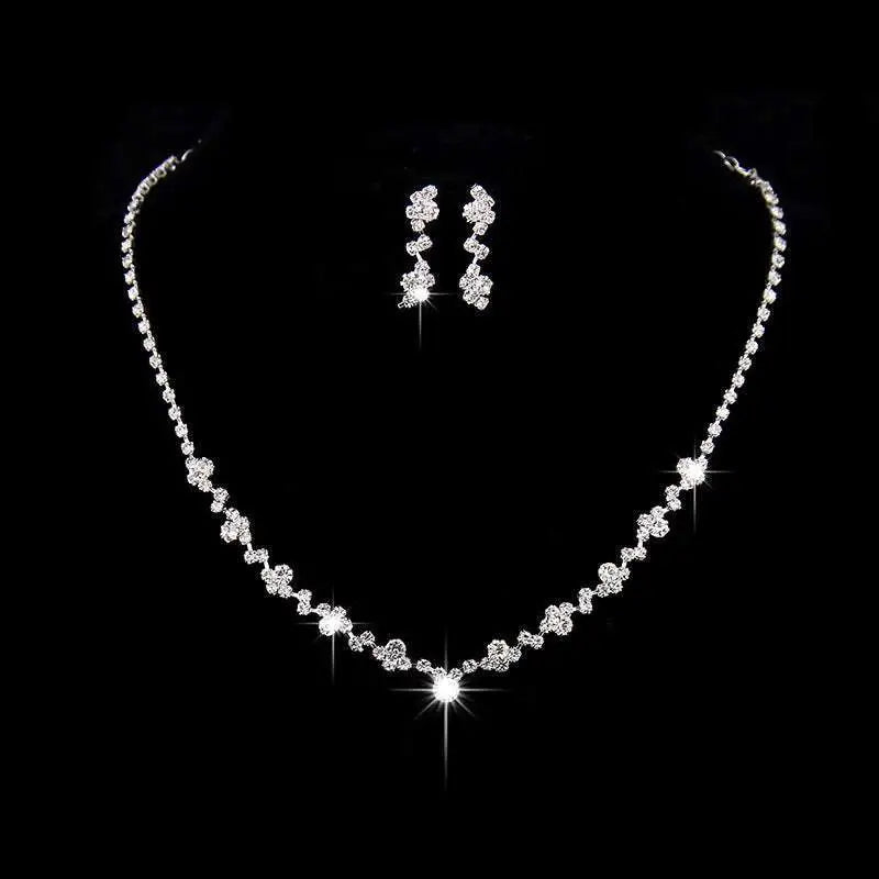 Sparkling silver floral bridal necklace earrings two piece set with delicate chain and cascading clear rhinestone clusters