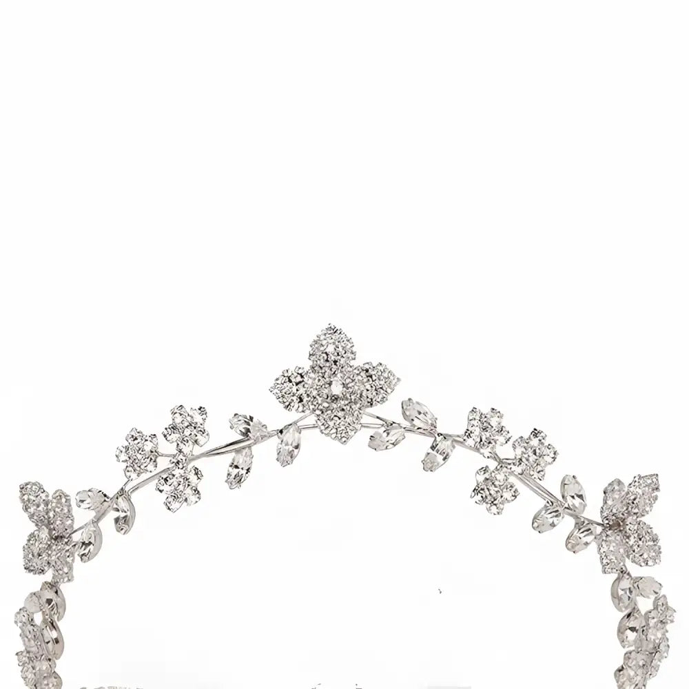 A delicate silver floral crystal zircon hair band adorned with sparkling crystal flowers and leaves with pearls