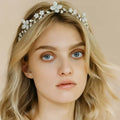 A delicate silver floral crystal zircon hair band adorned with sparkling crystals and tiny pearls for elegant wear