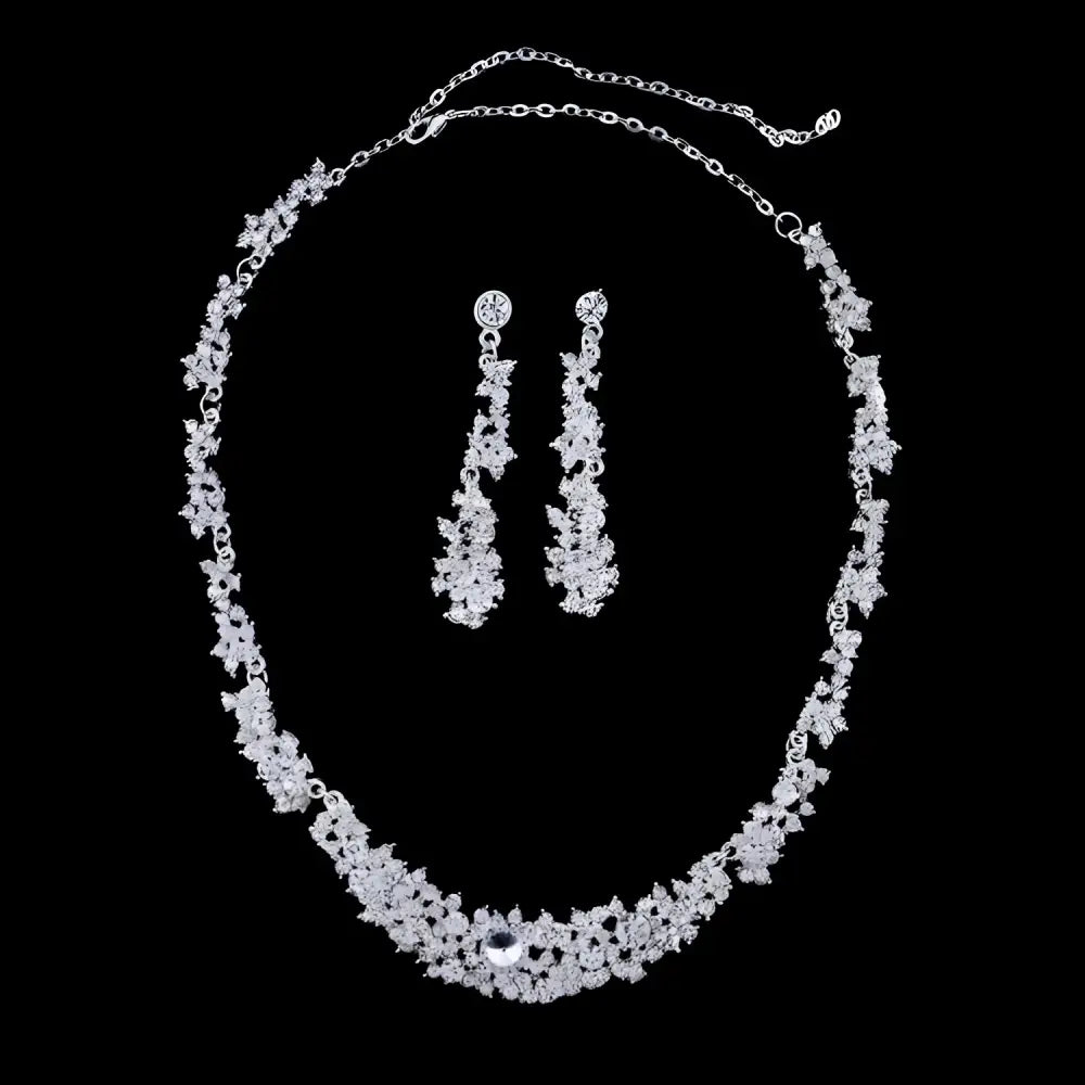 Silver floral jewelry necklace earrings set featuring a silver-toned crystal necklace with intricate floral design and matching drop earrings