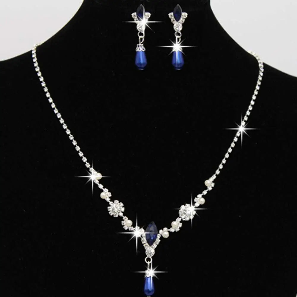 Silver floral personality dropspearl necklace set with sparkling crystals and blue teardrop pendants and matching earrings