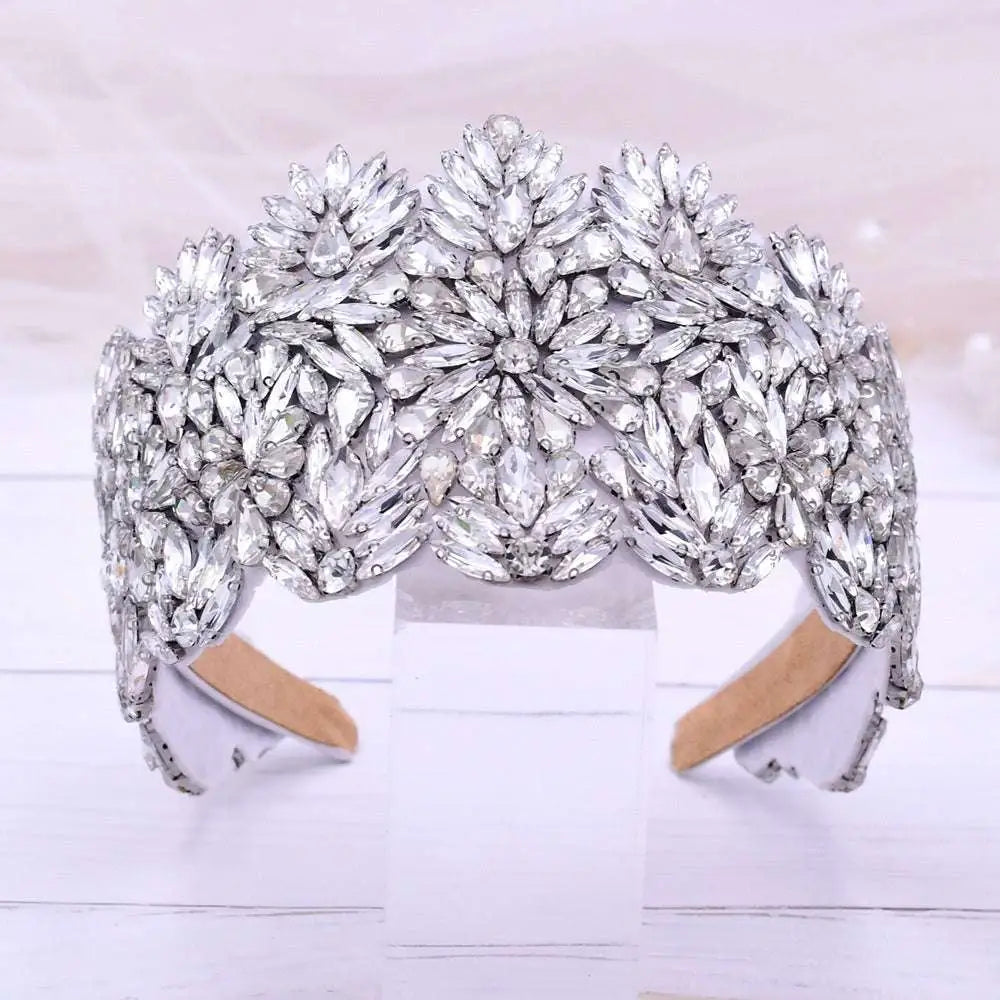 A fashion retro headband featuring a sparkling silver rhinestone with intricate silver floral rhinestone patterns