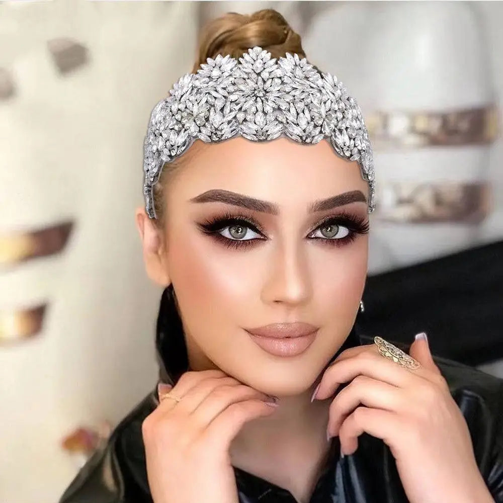 A fashion retro headband featuring a sparkling silver rhinestone with intricate silver floral rhinestone patterns