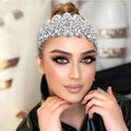 A sparkling silver rhinestone fashion retro headband with intricate silver floral rhinestone leaf and beaded design