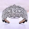 A sparkling silver rhinestone fashion retro headband with a silver floral rhinestone central design and scalloped edges