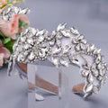 A sparkling silver rhinestone fashion retro headband with intricate silver floral rhinestone designs on a white base