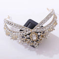 A gold-toned wedding crown headdress with silver floral details and clear oval crystal accents for weddings