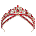 A glamorous gold wedding crown headdress with silver floral design and oval crystal accents featuring vibrant red and clear crystals
