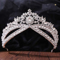 A silver floral wedding crown headdress featuring a sparkling oval crystal and intricate leaf and floral designs