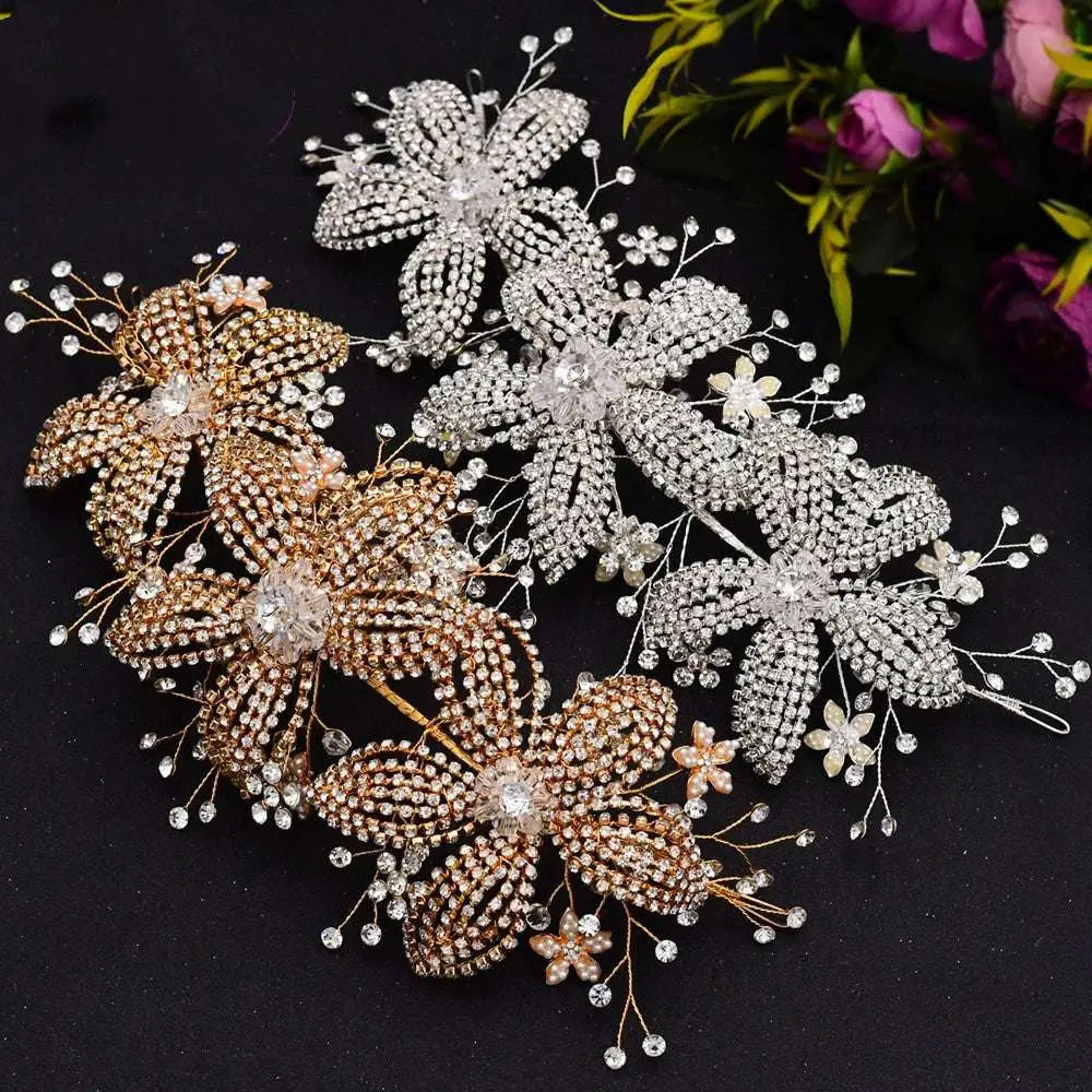 Silver flower rhinestone hair accessory with intricate leaf and stem designs and pearl accents for weddings