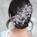 Silver flower rhinestone hair accessory with delicate lace patterns and pearl accents for weddings