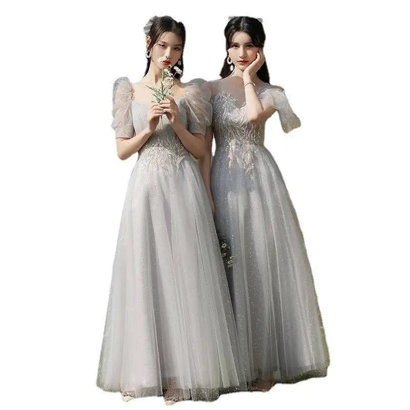 Two women wearing silver gray tulle beaded sisters dress female with off-the-shoulder puffy sleeves and intricate bodices