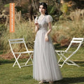 A shimmering silver gray tulle beaded a-line sisters dress female with short puffed sleeves and lace detailing