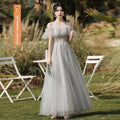 A silver gray tulle beaded off-shoulder sisters dress female with intricate lace and flowing tulle skirt
