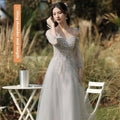 Silver gray tulle beaded sisters dress female featuring a shimmering silver sequined gown with sheer off-the-shoulder sleeves and flowing skirt