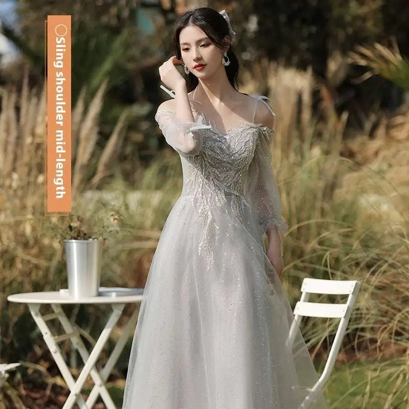 Silver gray tulle beaded sisters dress female featuring a shimmering silver sequined gown with sheer off-the-shoulder sleeves and flowing skirt