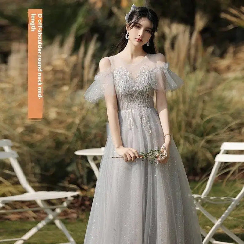 A shimmering silver gray tulle beaded sisters dress female with off-the-shoulder puffy sleeves and round neckline