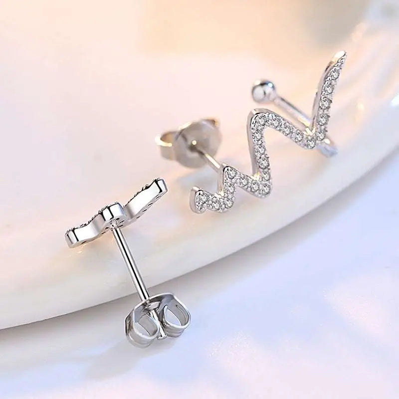 Silver zigzag stud earrings with clear crystals complementing the silver heartbeat korean lightning necklace