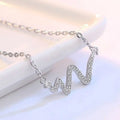 A delicate silver heartbeat korean lightning necklace with a zigzag pendant adorned with clear sparkling crystals