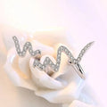 Silver heartbeat korean necklace featuring a silver ring with wavy zigzag design and sparkling clear stones