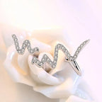 Silver heartbeat korean necklace featuring a silver ring with wavy zigzag design and sparkling clear stones