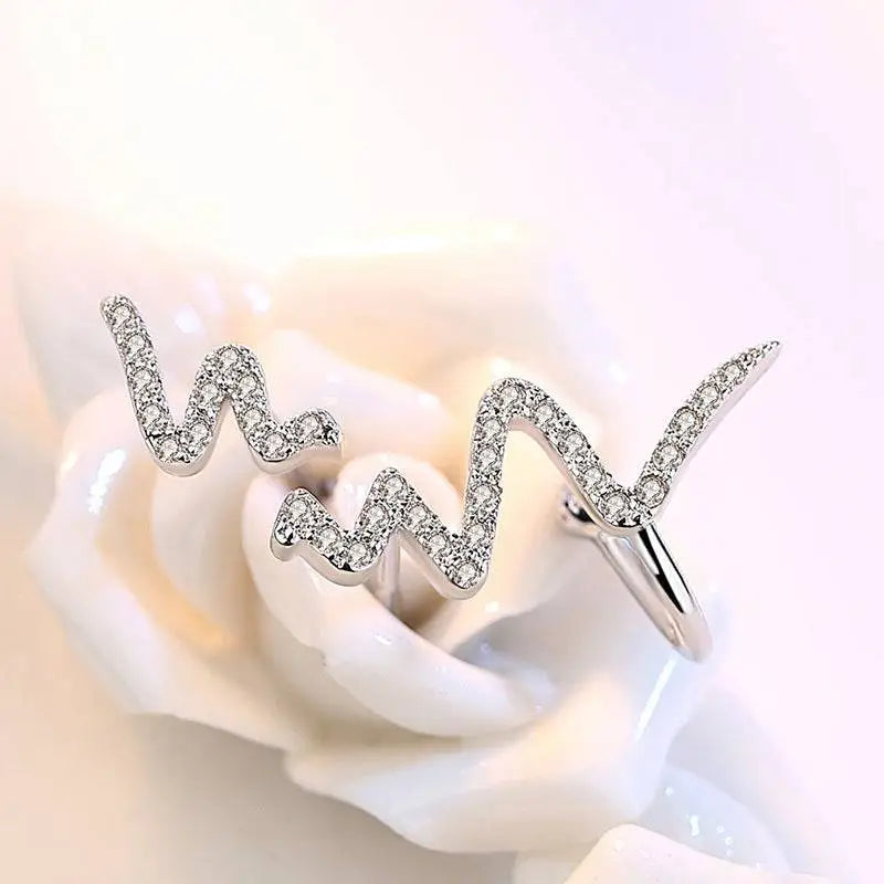 Silver heartbeat korean necklace featuring a silver ring with wavy zigzag design and sparkling clear stones