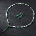 Emerald and white crystal tennis necklace set with silver-toned clasp paired with silver leaf cubic zirconia bride wedding earrings