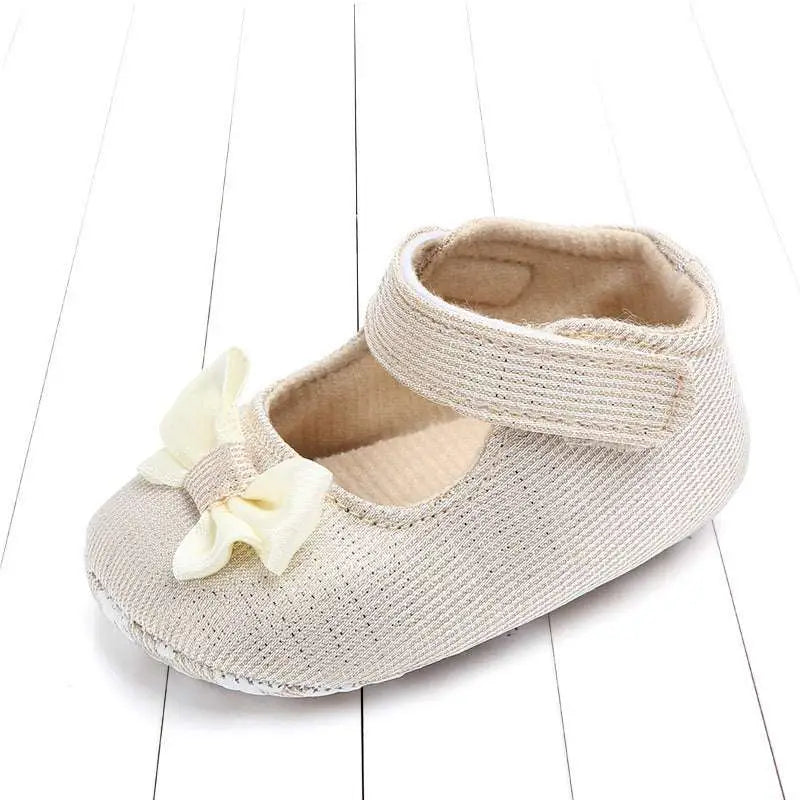 Beige woven fabric baby shoe with cream satin bow, a matching satin detail in silver mesh princess shoes bow for babies