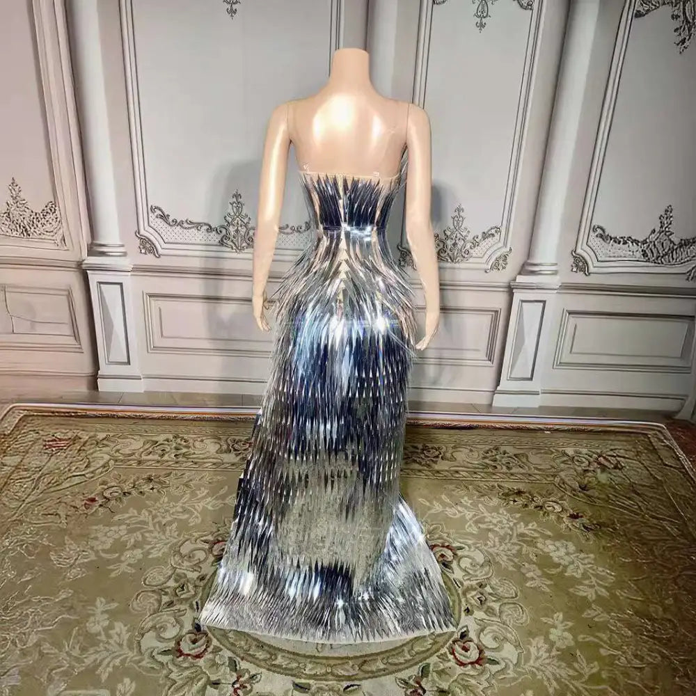 Back view of a silver metallic sequined luxury evening dress with a structured corset and cascading fringe detailing for stage advanced light use