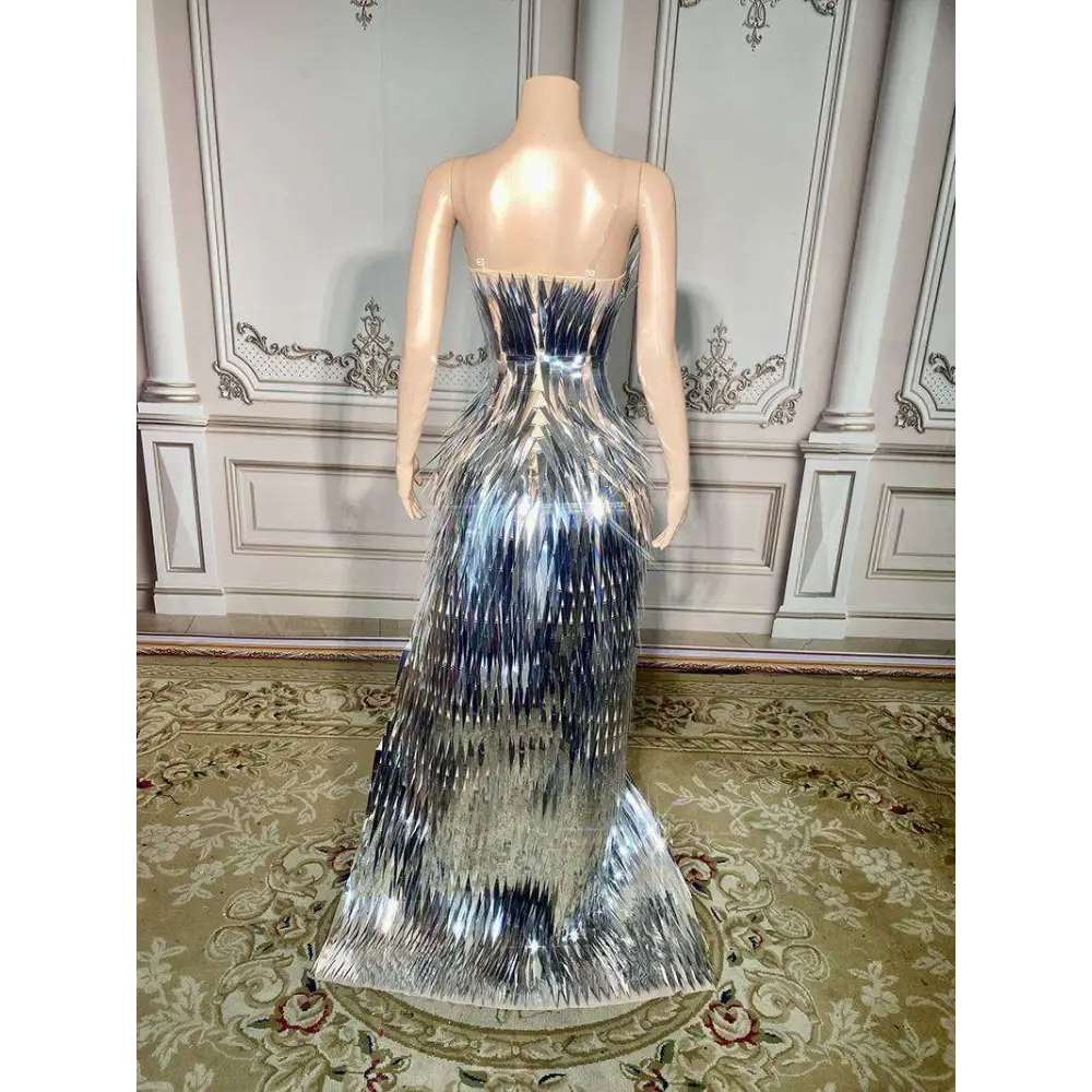A silver metallic sequined luxury evening dress with fitted bodice and layered fringe for stage advanced light events