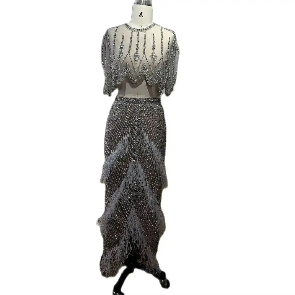 Silver nude feathered two-piece evening dress with a sheer embellished top and layered feathered skirt